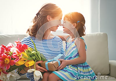 Happy mother`s day! child daughter gives mother a bouquet of f Stock Photo