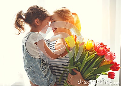 Happy mother`s day! child daughter gives mother a bouquet of f Stock Photo