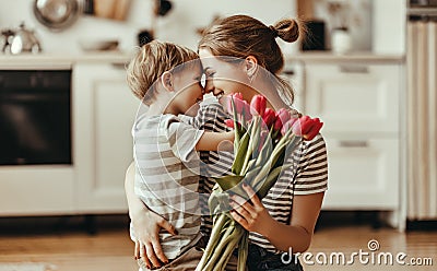 Happy mother`s day! child son gives flowers for mother on holiday Stock Photo