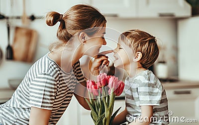 Happy mother`s day! child son gives flowers for mother on holiday Stock Photo