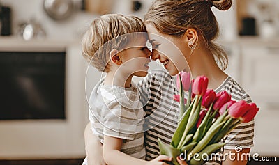 Happy mother`s day! child son gives flowers for mother on holiday Stock Photo