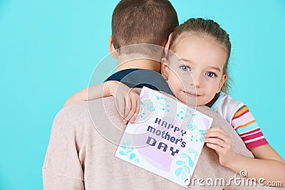 Happy Mother`s Day. Cute little girl giving mom mothers day card. Mother and daughter concept. Stock Photo