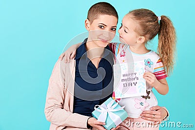 Happy Mother`s Day. Cute little girl giving mom mothers day card and a present. Mother and daughter concept. Stock Photo