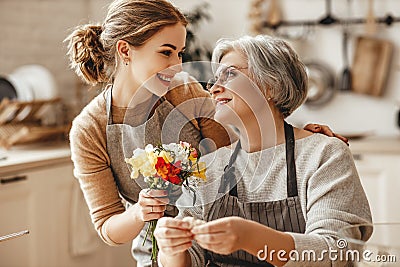 Happy mother`s day! family old grandmother mother-in-law and daughter-in-law daughter congratulate on holiday, give flowers Stock Photo