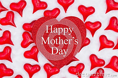 Happy Mother`s Day greeting on glitter heart with red hearts on white fabric Stock Photo