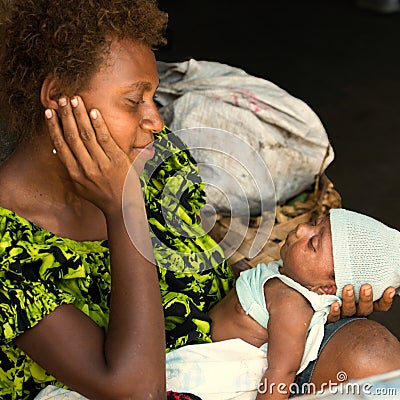 Happy mother with newborn baby. Mum looking gladly to newborn child, Rabaul, Papua New Guinea Editorial Stock Photo