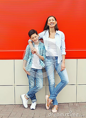 Happy mother and son teenager wearing casual clothes in city Stock Photo