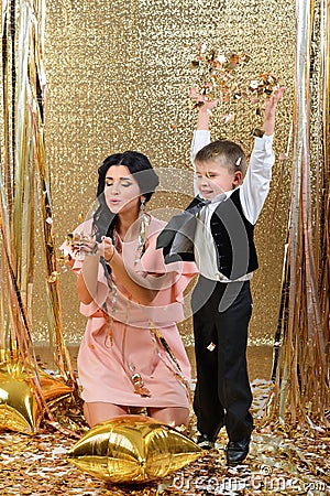 Happy mother and son throwing gold serpentine Stock Photo