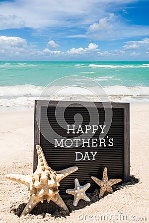 Happy Mothers day beach background with black board and starfishes Stock Photo