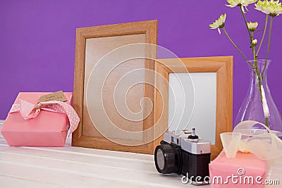 Happy mothers day card on gift box with wooden frames and camera Stock Photo