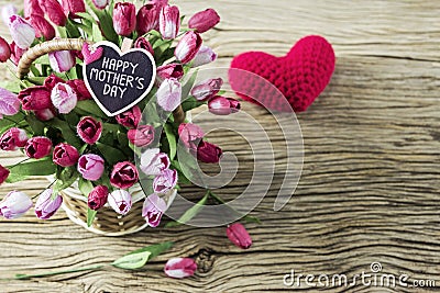 Happy mothers day of pink and red tulip flowers in wood basket Stock Photo