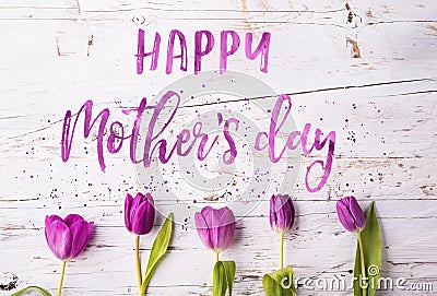 Happy mothers day sign and flowers composition. Studio shot. Stock Photo