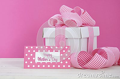 Happy Mothers Day white gift box with pink stripe ribbon. Stock Photo