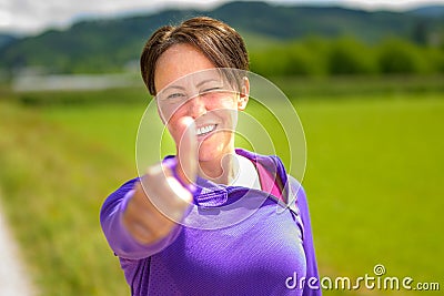 Happy motivated woman jogger giving a thumbs up Stock Photo