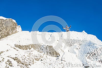 Happy The mountaineer climbed the mountain top covered with ice and snow, man hiker celebrating success at the peak of Stock Photo