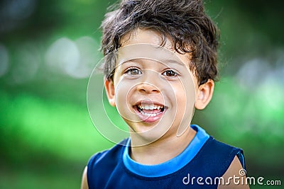 Happy mulatto boy child is smiling enjoying adopted life. Stock Photo