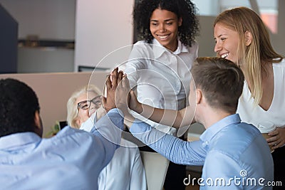 Happy employees giving high five focus on people hands Stock Photo