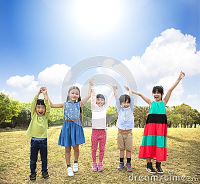 Multi-ethnic group of school children in park Stock Photo
