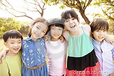 Multi-ethnic group of schoolchildren in park Stock Photo