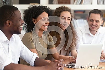 Happy multi ethnic research team working together using laptop Stock Photo