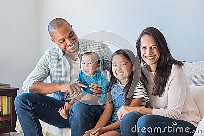 Happy multiethnic family on sofa Stock Photo