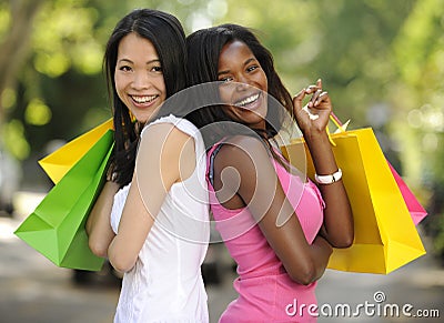 Happy multiethnic friends shopping Stock Photo