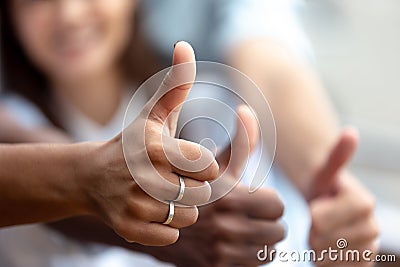 Happy multiethnic friends showing thumbs up close up Stock Photo