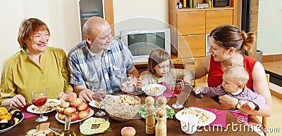 Happy multigeneration family communicate over table Stock Photo