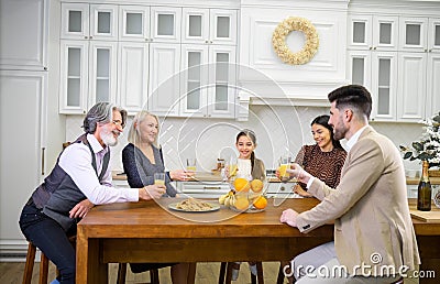 Happy multigenerational family celebrating birthday of little girl in kitchen Stock Photo