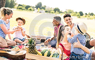 Happy multiracial families having fun with kids at picnic barbecue party - Multicultural happiness on joy and love concept Stock Photo