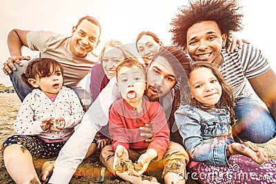 Happy multiracial families taking selfie at beach making funny faces Stock Photo