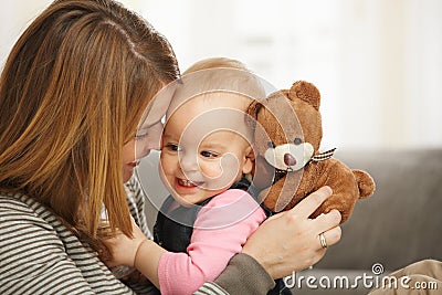 Happy mum and baby with teddy bear Stock Photo