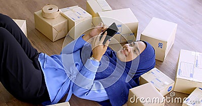 Happy muslim merchandiser woman checking online order in the office Stock Photo