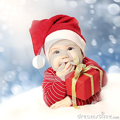 Happy New Year baby with red gift on snow Stock Photo