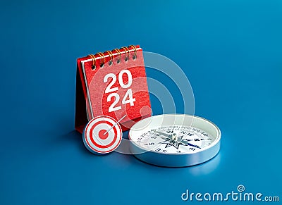 3d Target icon, 2024 numbers year on red desk calendar cover stand and compass on blue background. Stock Photo