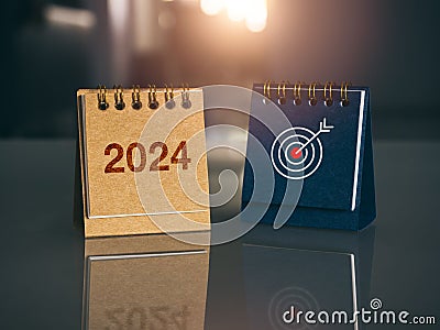 Happy new year 2024 banner background. 2024 number year with target icon on brown and blue small desk calendar cover. Stock Photo