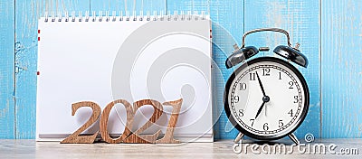 2021 Happy New Year with blank notebook, black retro alarm clock and wooden number. New Start, Resolution, Goals, Plan, Action Stock Photo