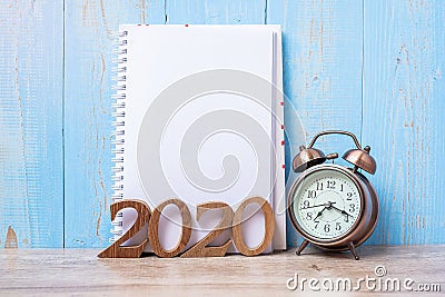 2020 Happy New Year with blank notebook, retro alarm clock and wooden number. New Start, Resolution, Goals, Plan, Action and Stock Photo