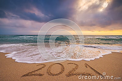 Happy New Year 2021 concept, lettering on the beach and Sea sunrise Stock Photo
