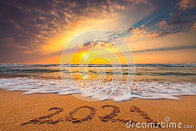 Happy New Year 2021, lettering on the beach. Written text on the sea beach at sunrise Stock Photo