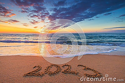 Happy New Year 2023 concept, lettering on the beach. Written text on the sea beach at sunrise Stock Photo