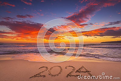 Happy New Year 2024 concept, lettering on the beach. Written text on the sea beach at sunrise Stock Photo