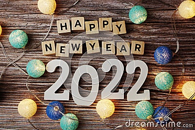 Happy New Year 2022 decorate with LED cotton ball on wooden background Stock Photo