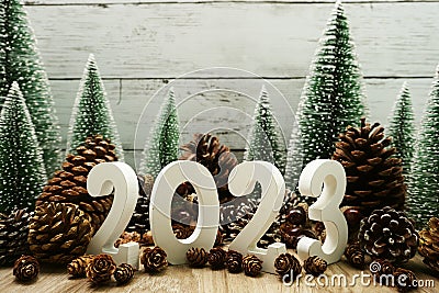 Happy New year 2023 decoration with Christmas tree and pine cones on wooden background Stock Photo