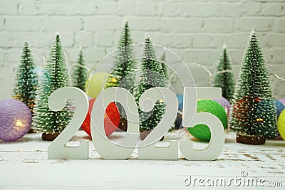 Happy New Year 2025 festive background with christmas tree on white brick wall background Stock Photo