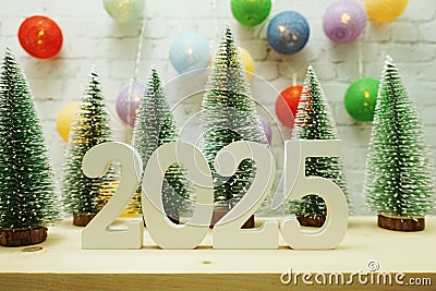 Happy New Year 2025 festive background with christmas tree on white brick wall background Stock Photo