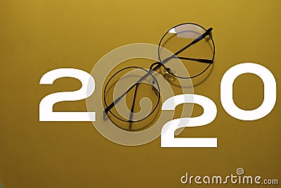 Happy New Year 2020 with Glasses isolated on yellow background Stock Photo