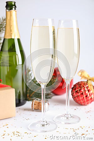 Happy New Year! Glasses of sparkling wine and festive decor on white background Stock Photo