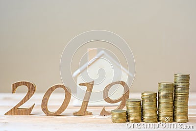 2019 Happy New Year with gold coins stack and wooden number on table. business, investment, retirement planning, finance, Saving a Stock Photo