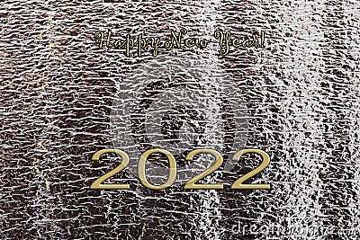 Happy New Year 2022 in gold numeral with Happy New Year handwriting on a silver aluminum background with reflection Stock Photo
